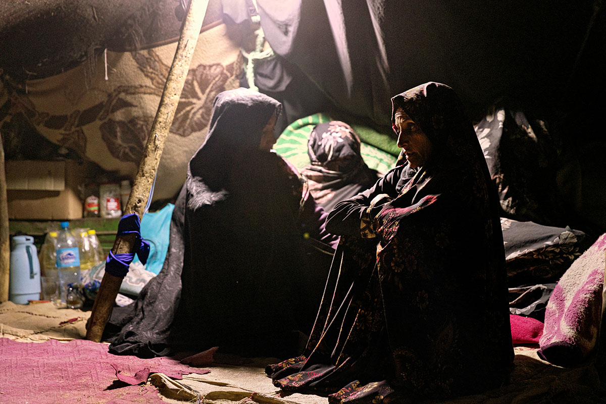 Hanifa and her two neighbours huddle in a makeshift tent to mourn those they’ve lost.
