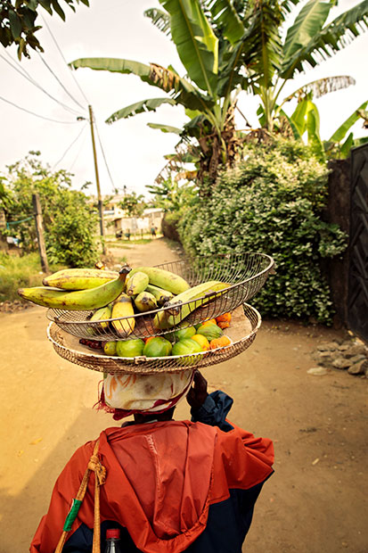 Christine Banlog brings home produce that she did not sell. Photo: UN Women/Ryan Brown