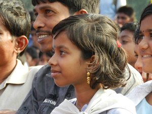 A father and daughter watch an interactive theatre performance in the field at her school in Satkhira, Bangladesh.