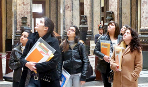 Six of the 25 young women leaders who took part in the tutorials visit the Legislative Palace in Montevideo.
