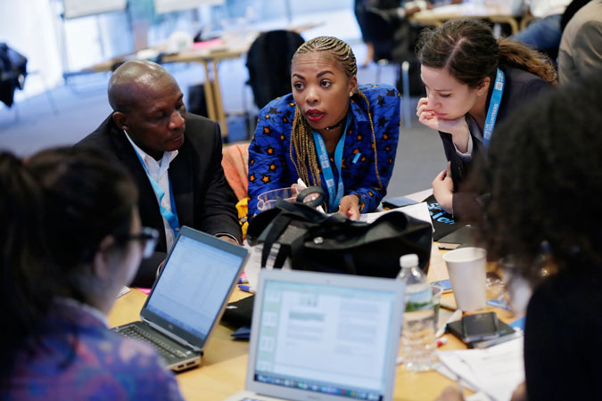 Participants in the Global Gender-Responsive Peacebuilding Learning and Strategy Workshop, Norbert Mweze Carangabo , Angela Mejane Nnoko and Silvia Olivotti discuss gender-responsive conflict analysis. Photo: UN Women/Ryan Brown