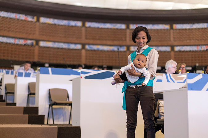 Conference participant with baby. Photo: UN Women/Martín Jaramillo Serrano