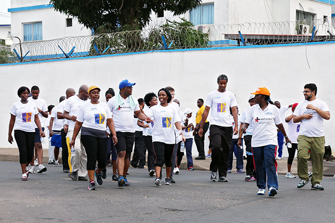 Every Saturday in Liberia, partners, friends and staff of UN Women and other UN agencies join together on a Wellness Walk around the Liberian capital, Monrovia. On her visit to Liberia, UN Women’s Executive Director joined the team for their warm-up exercises. Photo: UN Women/Stephanie Raison