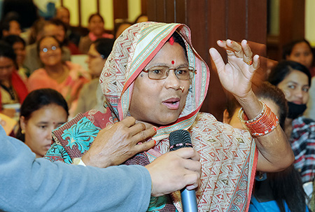 A woman in Nepal speaks up at an event contesting local polls. Photo: UN Women