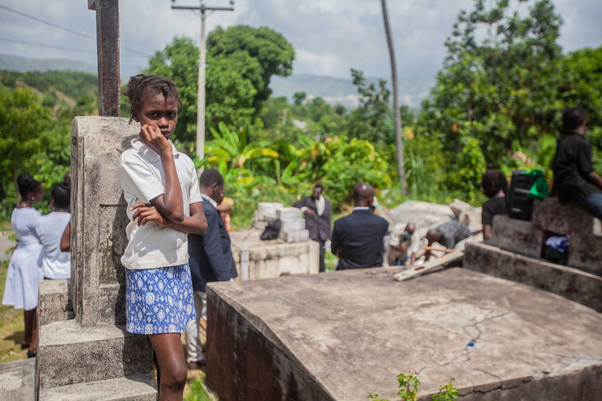 A girl attends the funeral of two victims of the last earthquake that struck Haiti on August 24, 2021 in the town of Marceline. Richard Pierrin/ AFP