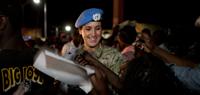 A Chilean Peacekeeper with the United Nations Mission in Haiti (MINUSTAH) hands out explanatory flyers at the inauguration of a bridge project in the northern Haitian city of Cap Haitian. MINUSTAH Engineers and Chilean Peacekeepers have completed major st