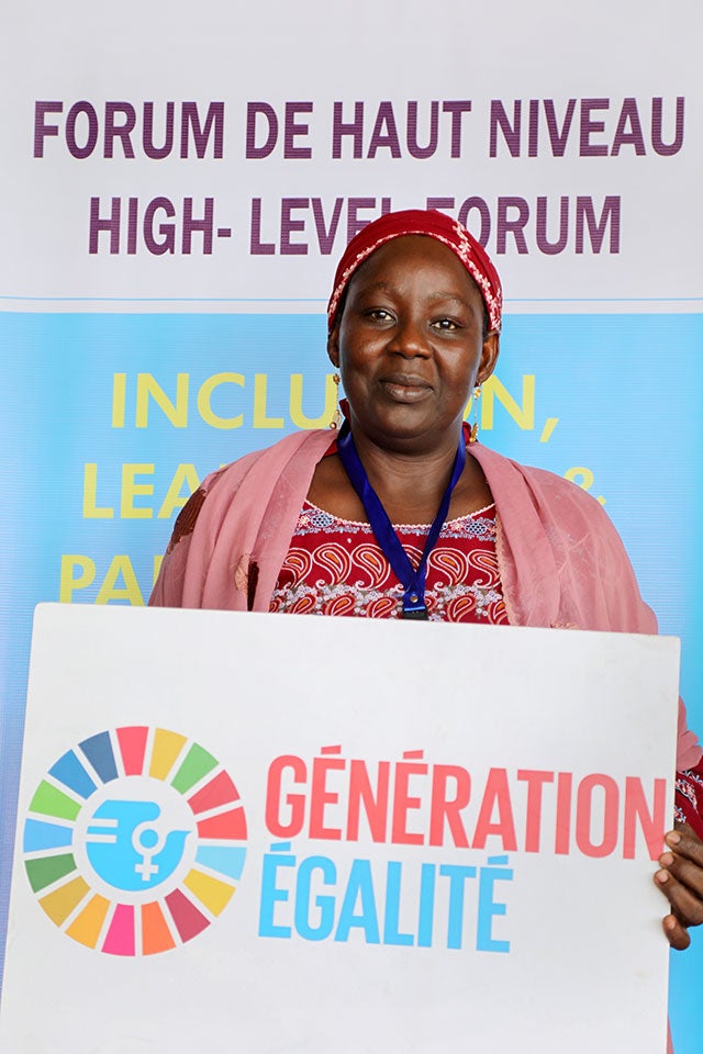 Aissa Doumara Ngatansou holds a Generation Egalite sign. 