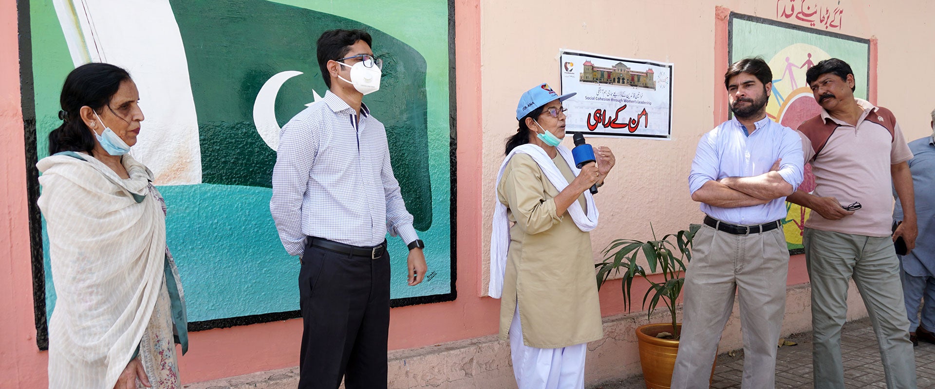 Shamim Awan, an artist from Karachi speaks in front of the murals she helped design, depicting a more tolerant, peaceful society. Photo: PAIMAN