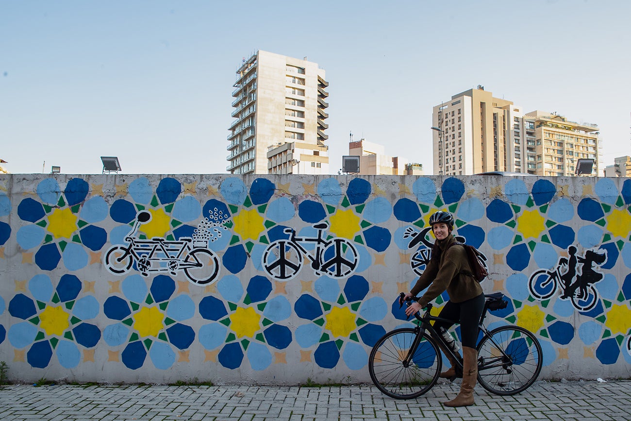 Nadida Raad in front of one of The Chain Effect’s murals. Photo: UN Women/Lauren Rooney