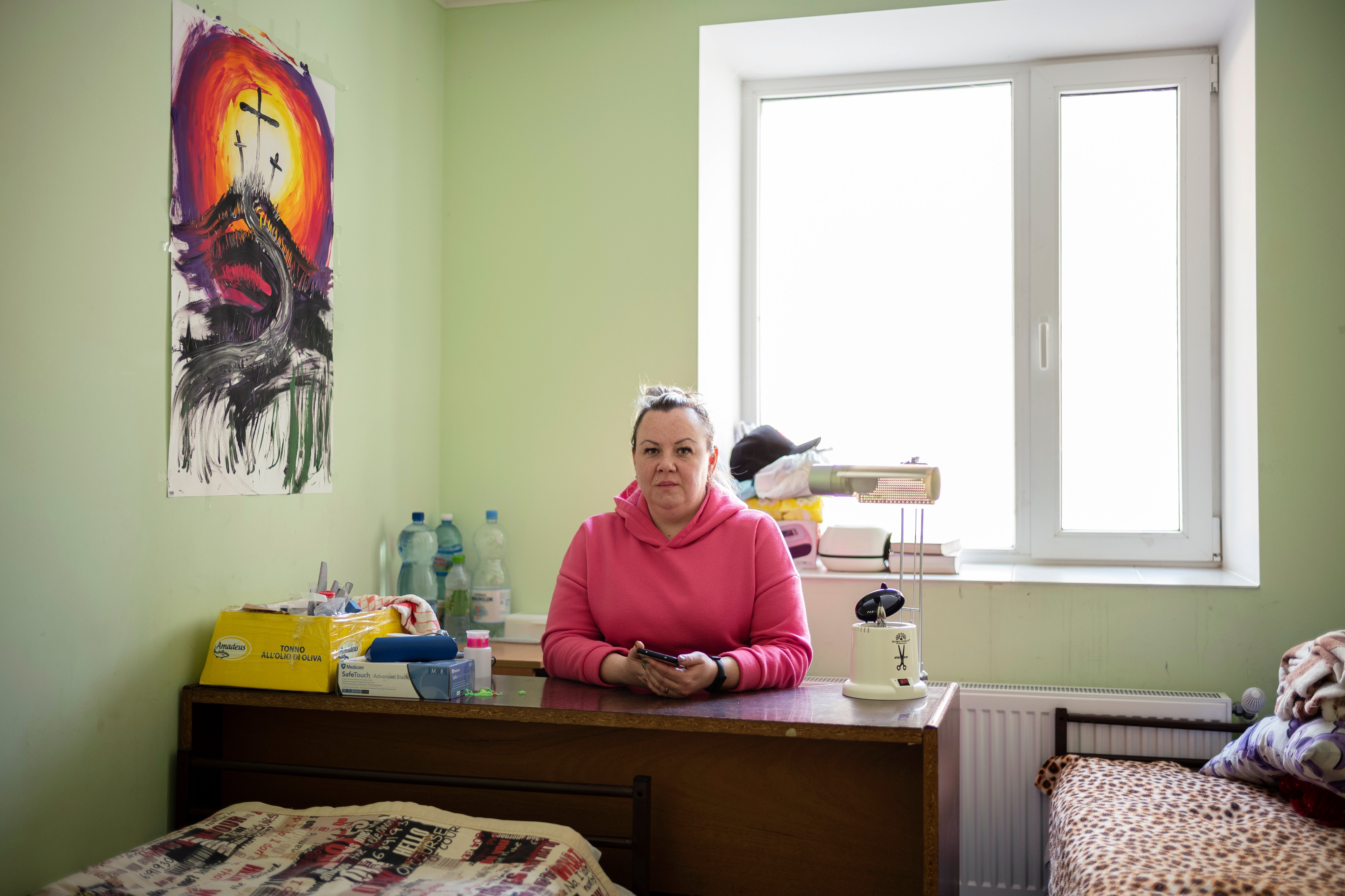 Marina, nail-artist from Odessa, at her work station in the temporary placement center in Vatici, Orhei district, Moldova.