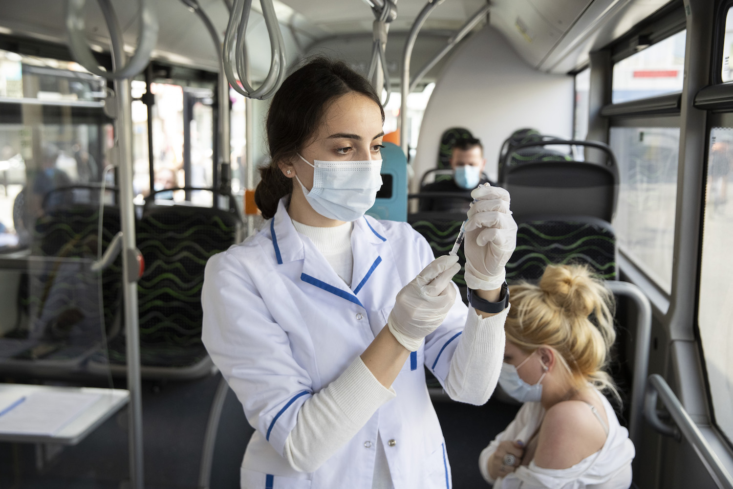 Aisa Ismailova, estudiante de medicina de 23 años, prepara una jeringa a bordo de un ómnibus vacunatorio en Tiflis (Georgia). Los ómnibus vacunatorios en los distritos de Tiflis han resultado ser un éxito, ya que las personas reciben la vacuna sin inscripción previa. 7 de septiembre de 2021 Fotografía: FMI/Daro Sulakauri.