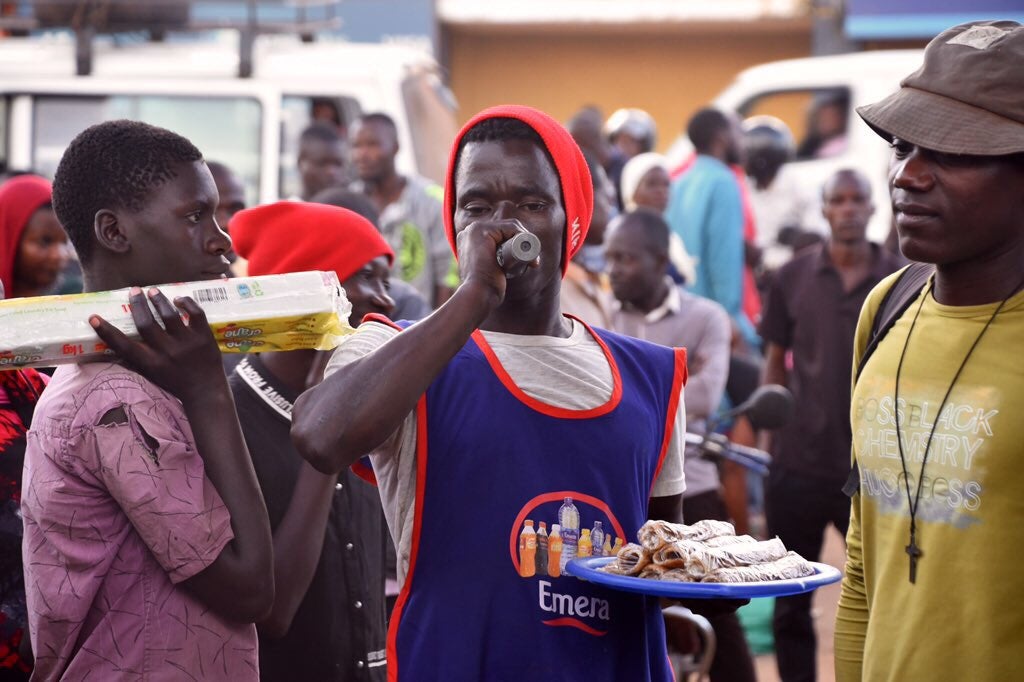 Under the Spotlight Initiative, UN Women and the Uganda Police Force engage male vendors on ending violence against women and girls as part of a 16 Days of Activism police caravan activity. Photo: UN Women/Eva Sibanda