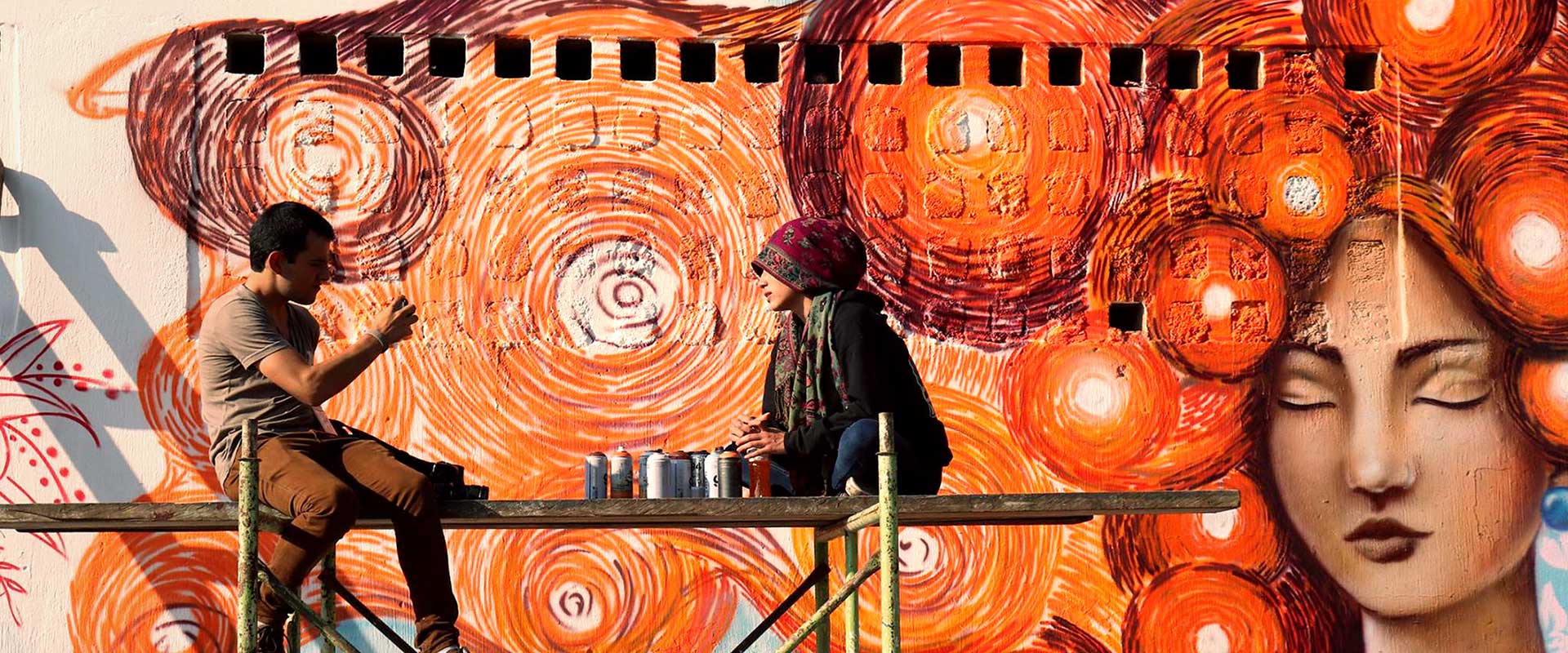 Un groupe de graffeurs (toutes de jeunes femmes) a peint des peintures murales orange dans la zone 18 de la ville de Guatemala en soutien à ONU Femmes et à la campagne Tous UNiS pour mettre fin à la violence à l'égard des femmes. Photo : ONU Femmes/Carlos Rivera
