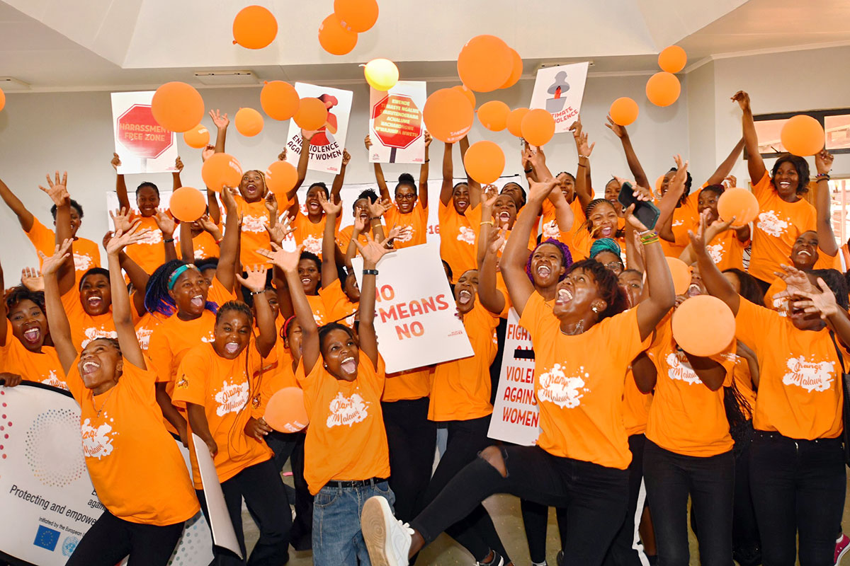 Youth participants in the "Uni Dialogue" to raise awareness around gender-based violence in Malawi rejoice with orange balloons. Photo: UN Women/Faith Mvula