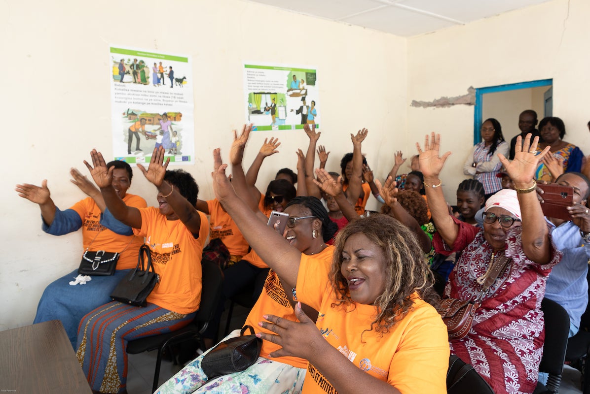 Twenty women vendors from the Mont Mgafula market celebrate receiving their business registration certificates at a ceremony at Mont Ngafula Town Hall on 6 October 2022. Photo: UN Women/Yulia Panevina