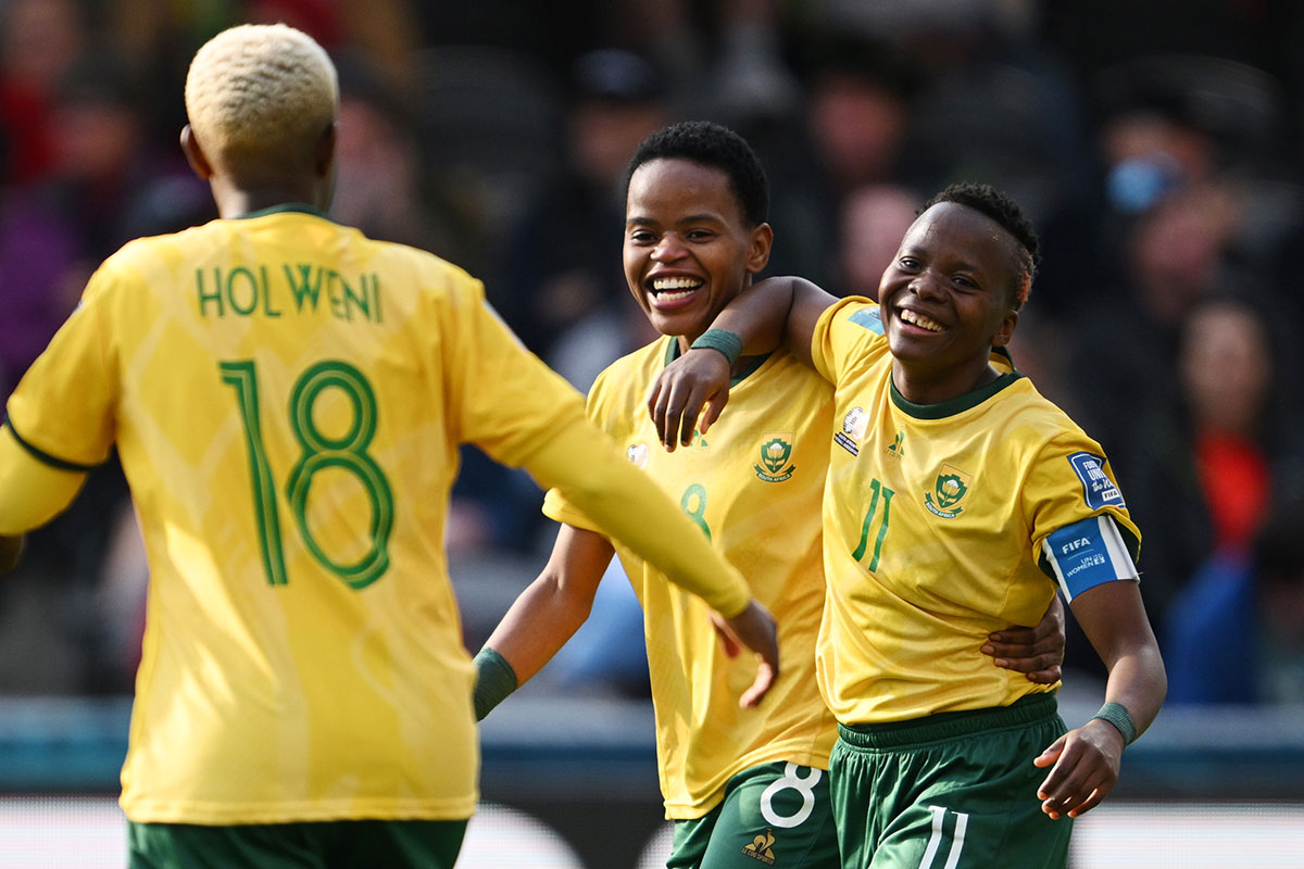 Thembi Kgatlana (right) of South Africa celebrates with teammates Hildah Magaia (centre) and Sibulele Holweni (left) after scoring her team’s second goal during the FIFA Women’s World Cup 2023 Group G match between Argentina and South Africa on 28 July 2023 in Dunedin/Ōtepoti, New Zealand. Photo: FIFA/Joe Allison.