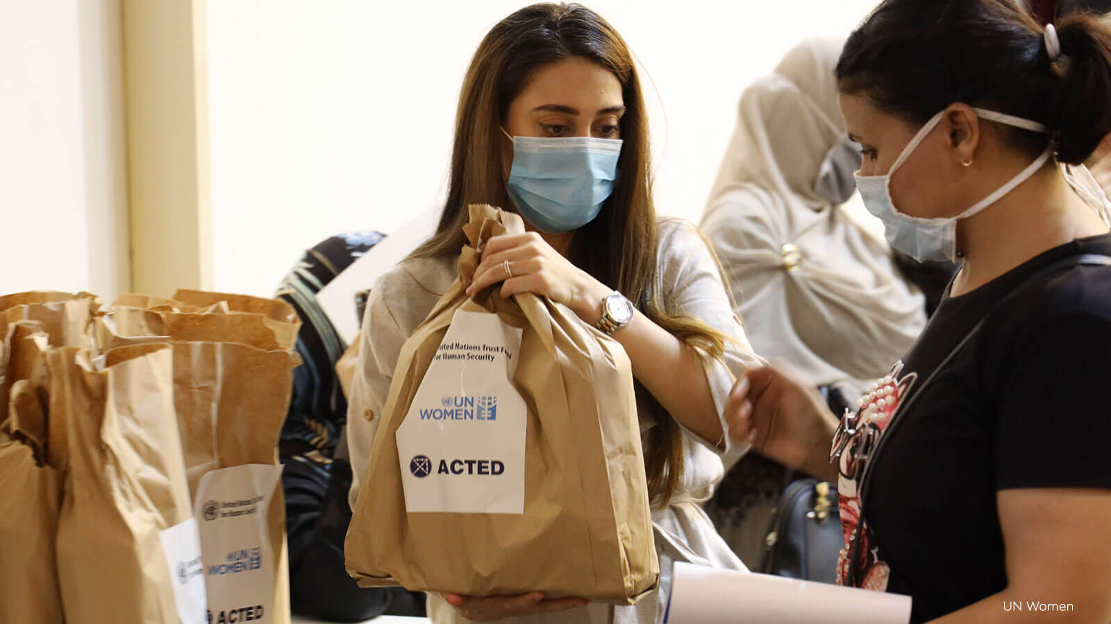 Workers on behalf of ACTED and UN Women distribute COVID-19 hygiene and dignity kits for women and girls in Tripoli, Lebanon. Photo: UN Women.