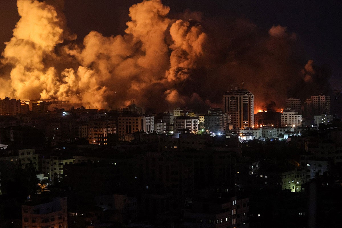 Flames and smoke billow during Israeli strikes in Gaza on 9 October 2023. 