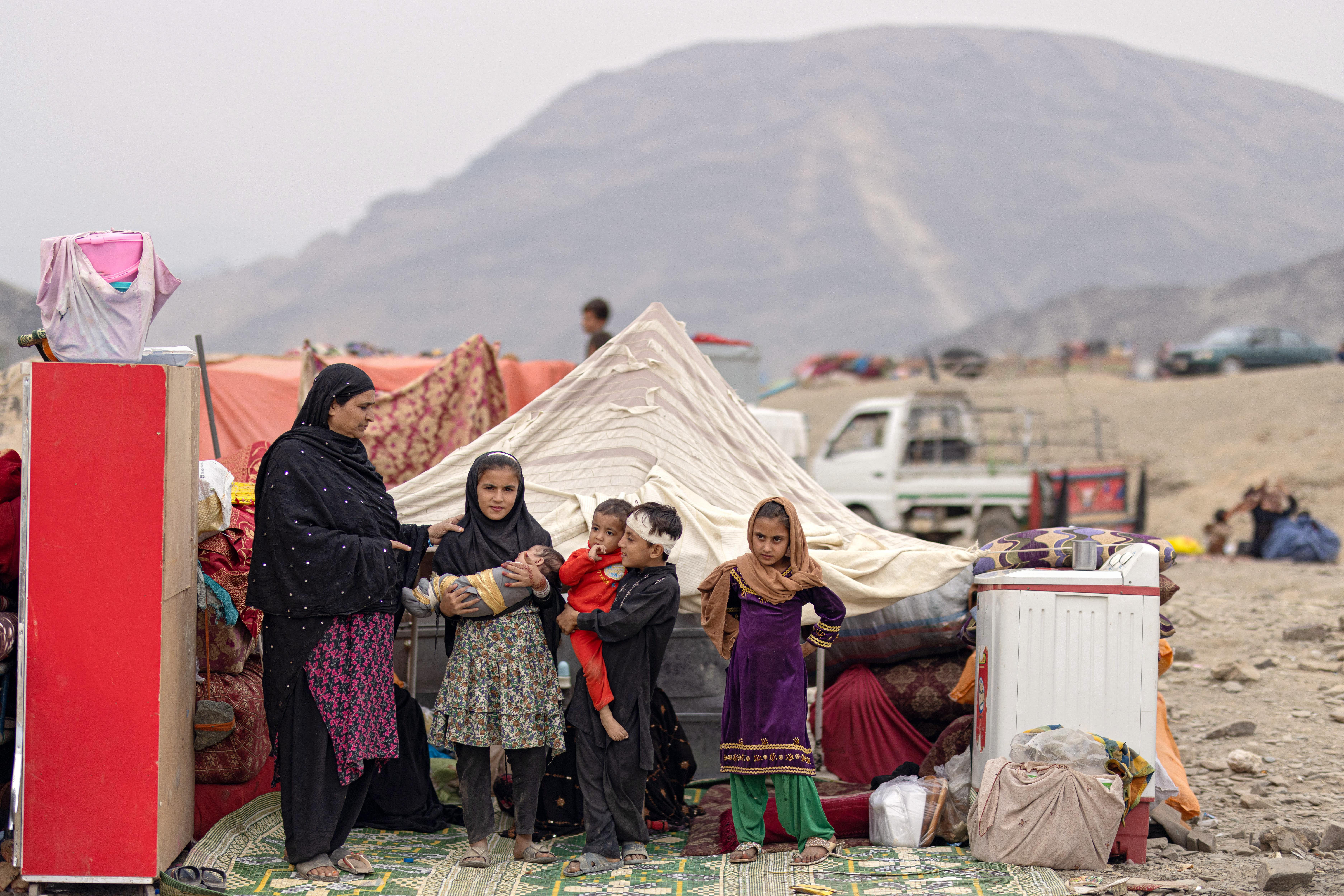 A woman and children are seen at the Torkham crossing point in Nangarhar, eastern Afghanistan, in November 2023 after they had been forced to return from Pakistan.