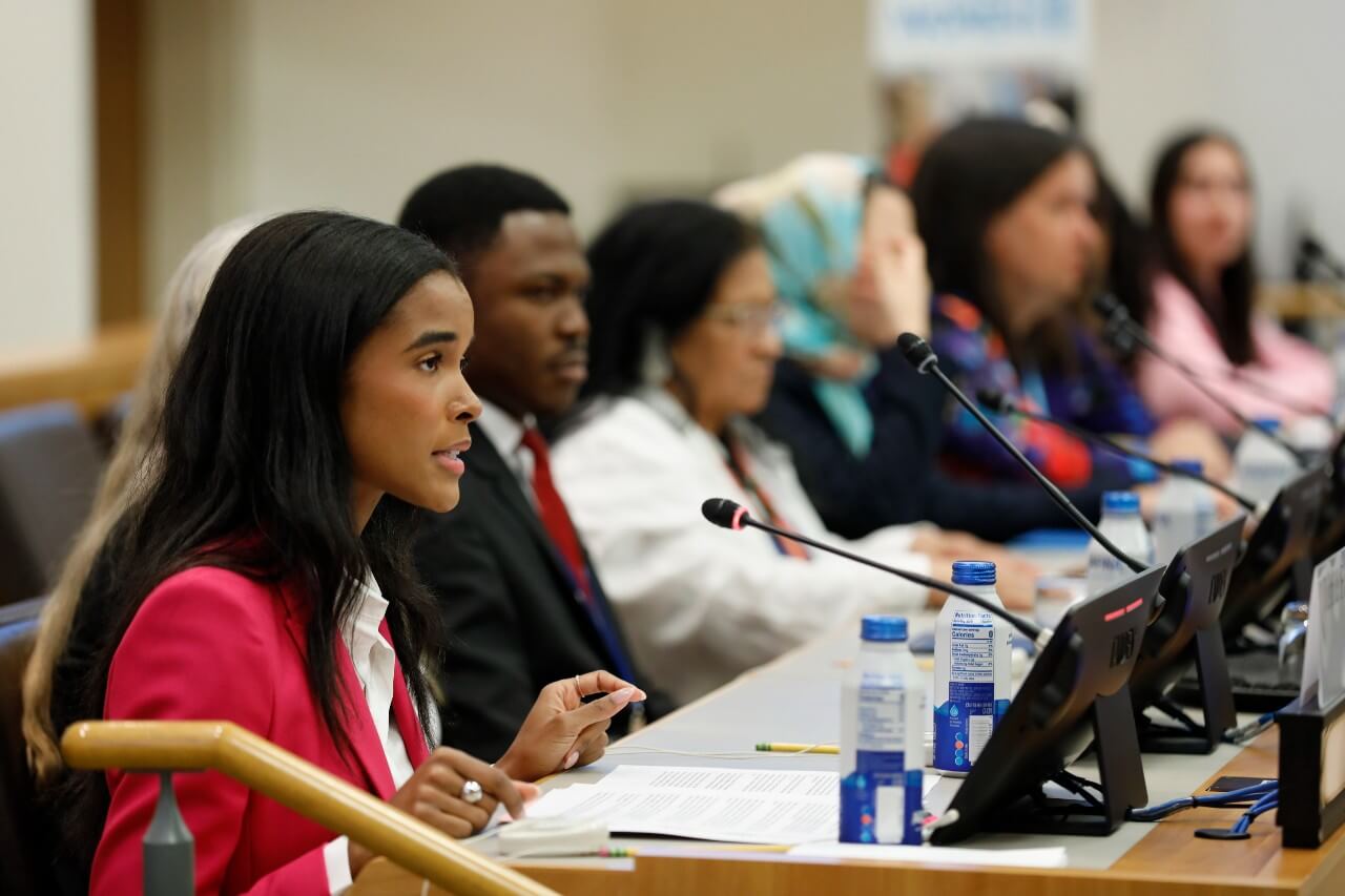 Ms. Justice Faith, Co-Founder of Révolutionnaire, moderates the Youth Forum opening on 15 March 2024 in UN headquarters. Photo: UN Women/Ryan Brown.