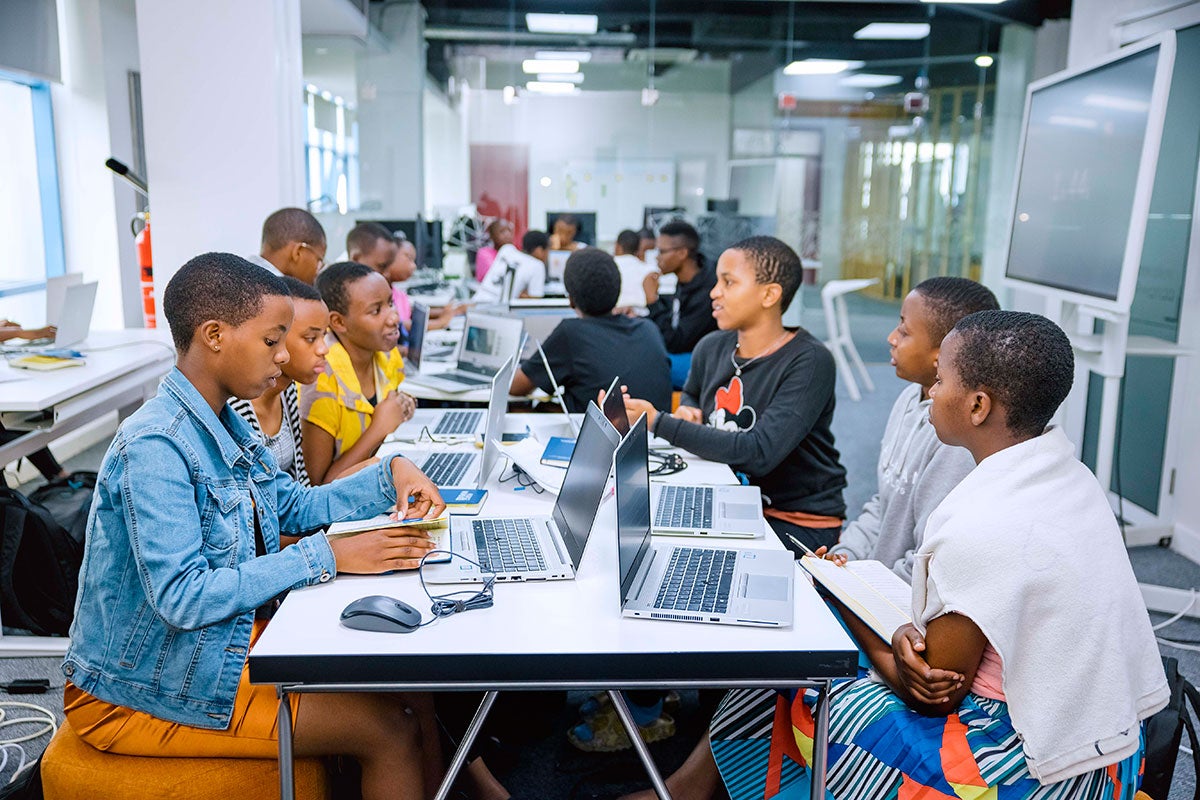 Young women participants work at laptops at during an AGCCI coding bootcamp held at the GIZ Digital Transformation Center in Kigali Rwanda in April 2024.