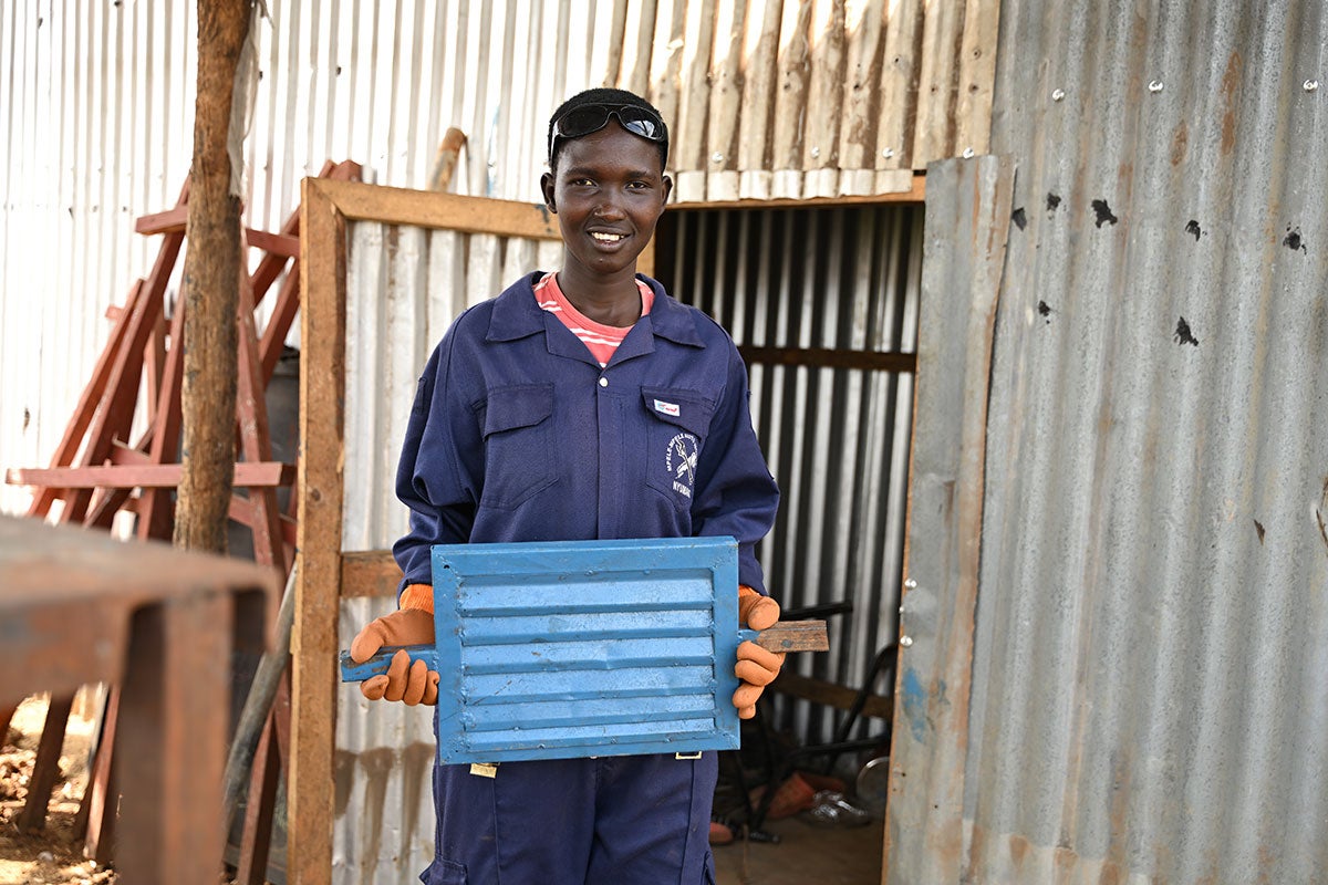 Veronica Konga, a host community member at Nyumanzi settlement, with one of the products she welded as part of her training.