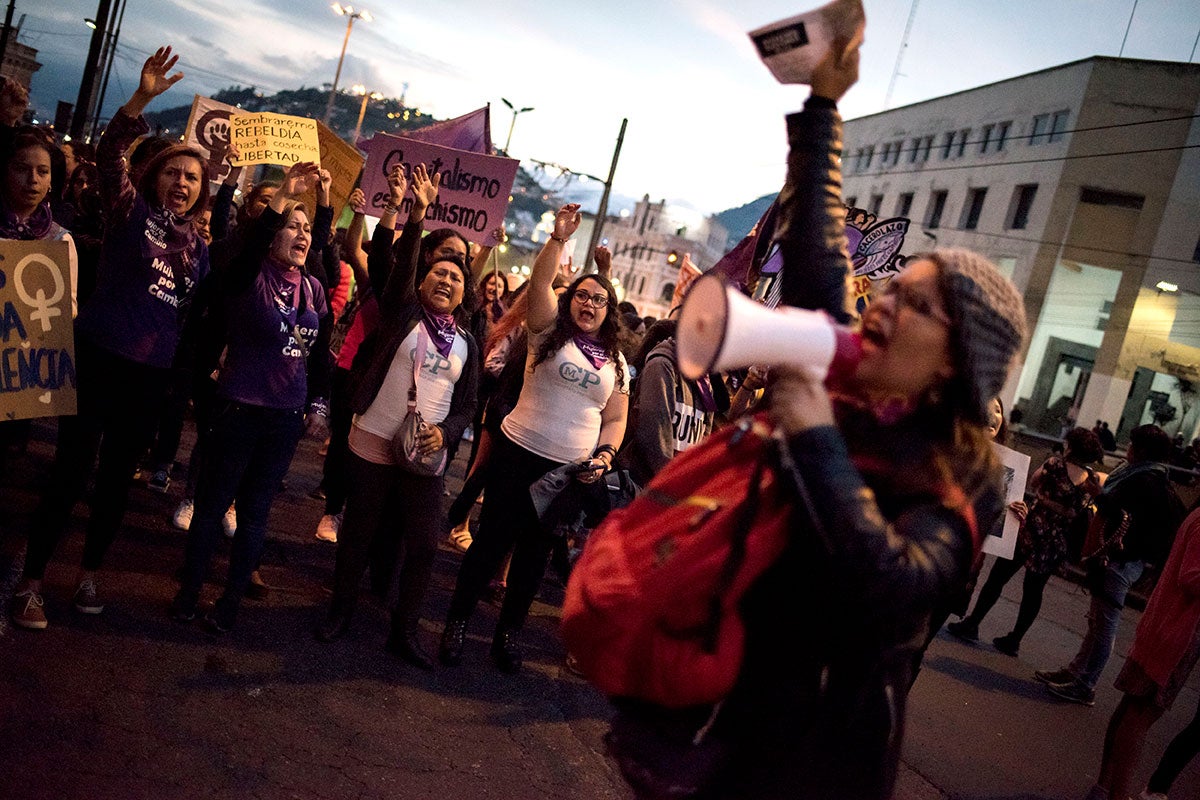 Activists, social leaders, and other rights defenders shout slogans against gender-based violence during a march in Ecuador.
