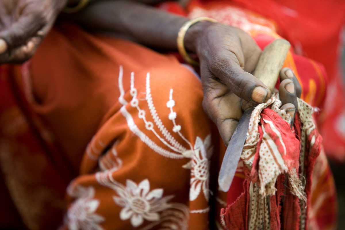 Boko Mohammed, a former excisor (a practitioner who performs female genital mutilation), holds the tool she used to perform the procedure at a community meeting in Kabele Village, inAmibara District, Afar Region.