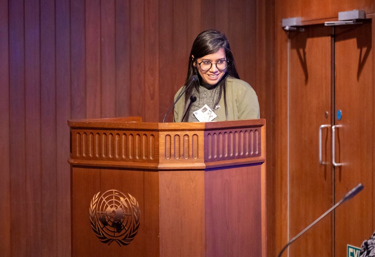 Sushmita S. Preetha speaks at a podium with the United Nations logo