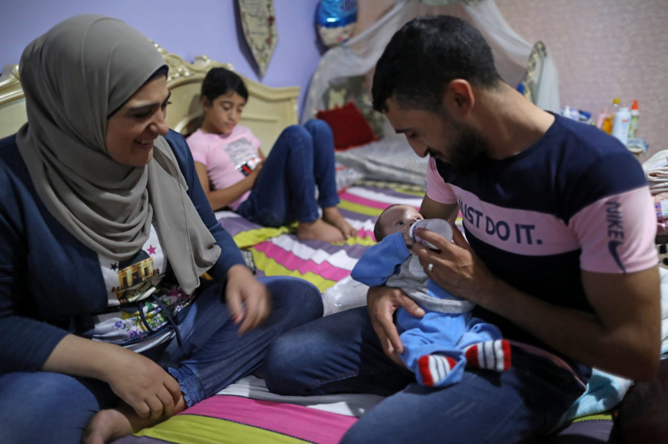The couple take turns caring for Walid, their son, whether it’s bottle feeding, childcare or other housework. Photo: UN Women/Marwan Tahtah.