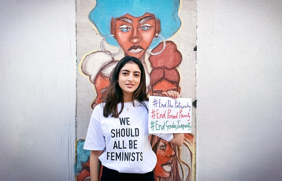 Nanda shows her messages outside Fashion Institute of Technology In New York City, on 3 April 2021. Behind her is a student-painted mural on the theme of Black Lives Matter, with a focus on empowering black women. Courtesy of Gauri Kanade