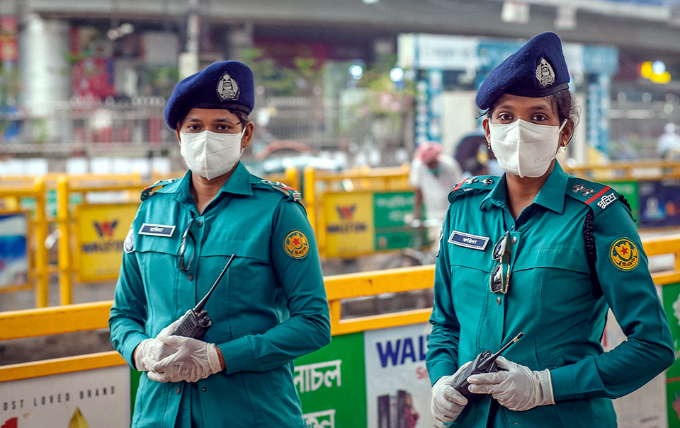 Two female police officers of Dhaka Metropolitan Police patrolling streets in Dhaka, Bangladesh. The visible presence of female police officers makes women feel safer. Taken on 3 June 2020.