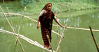 Woman in India crosses bridge