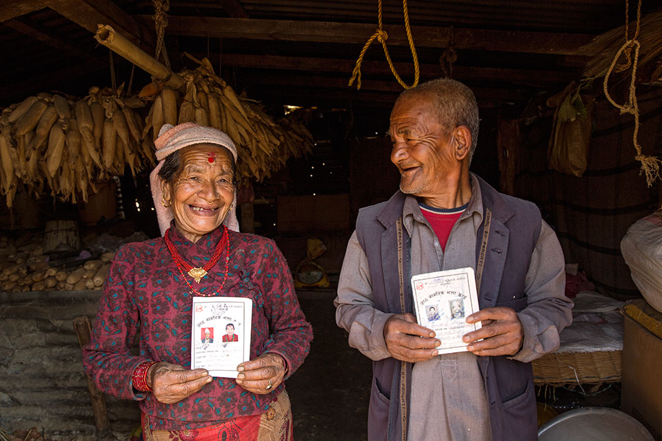 Bishnu Maya Dangal and her husband show their senior citizen cards. Photo: UN Women/ N Shrestha