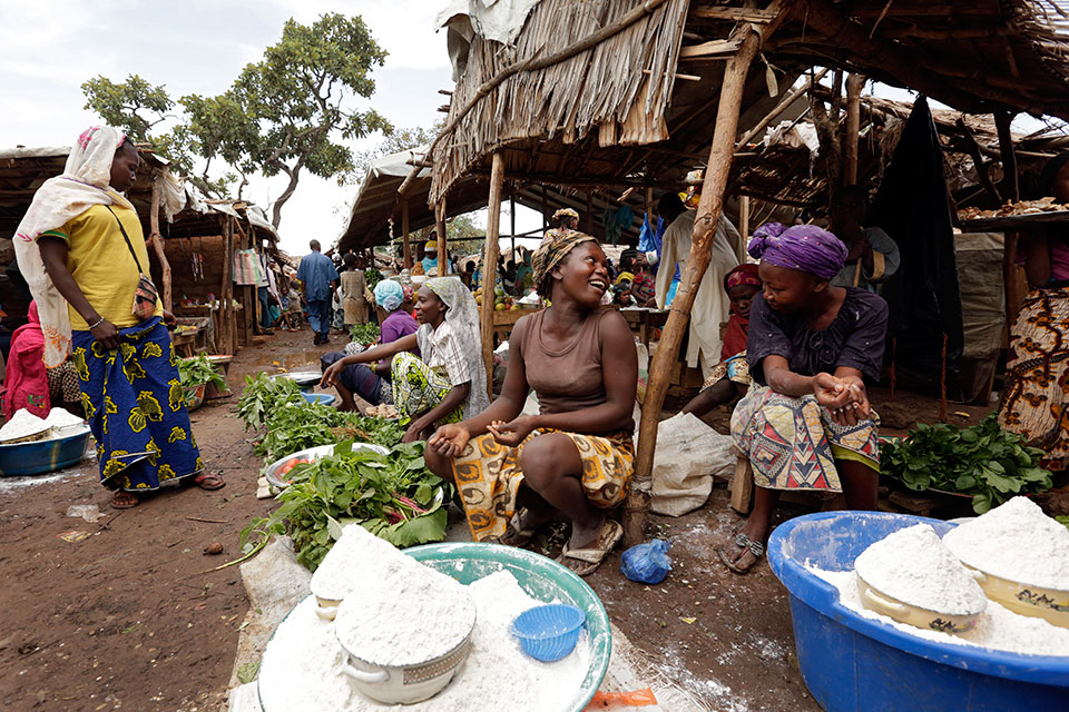 Women sell home-grown vegetables and cassava flour at the market in the Gado-Badzere refugee camp. Photo: UN Women/Ryan Brown