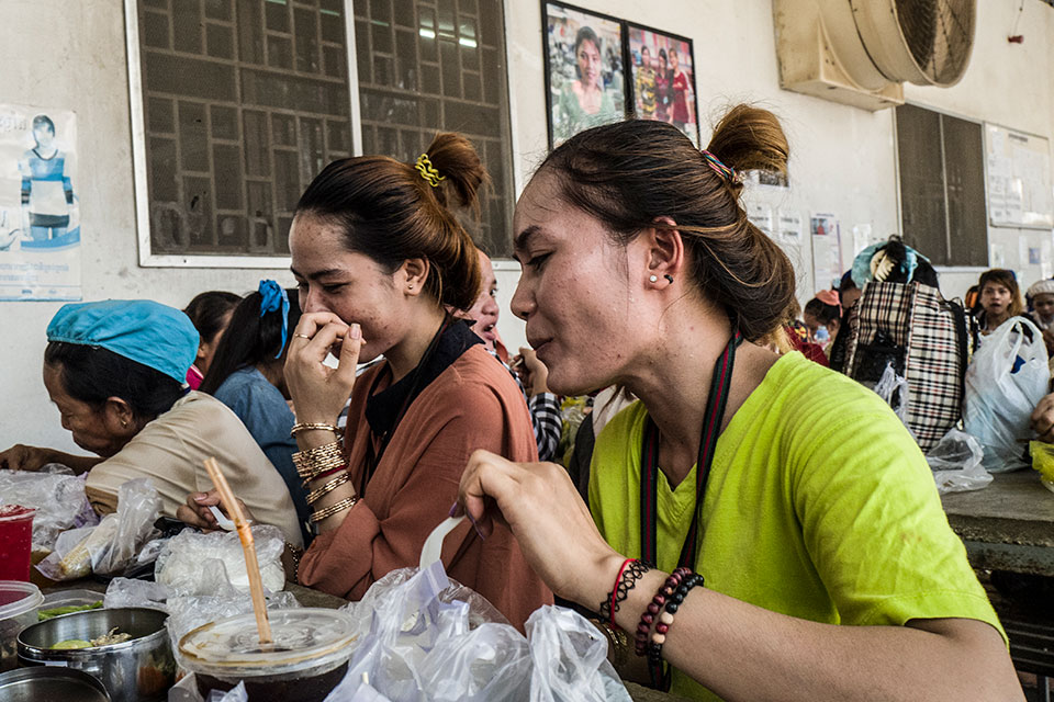 Srey Sros, enjoys lunch with her sister Srey Roth, who is 23 years old. Photo: UN Women/Charles Fox