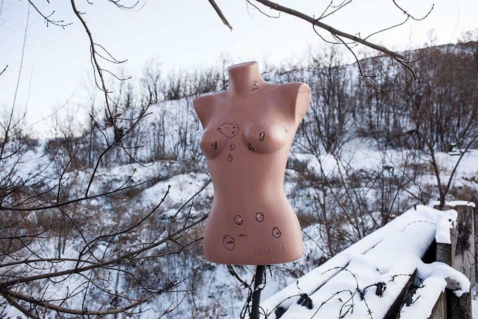 UKRAINE. Petrovskyi neighborhood, East Ukraine. 2014. A female mannequin from a destroyed market is used for target practice at a separatist shooting range. During and after conflict, women and girls often experience gender-based violence. Protection measures against sexual violence during armed conflict have been addressed in Resolutions 1325, 1820 and 1888, yet, gender-based violence in conflict continues, perpetuating gender inequalities. ©Larry Towell/Magnum Photos