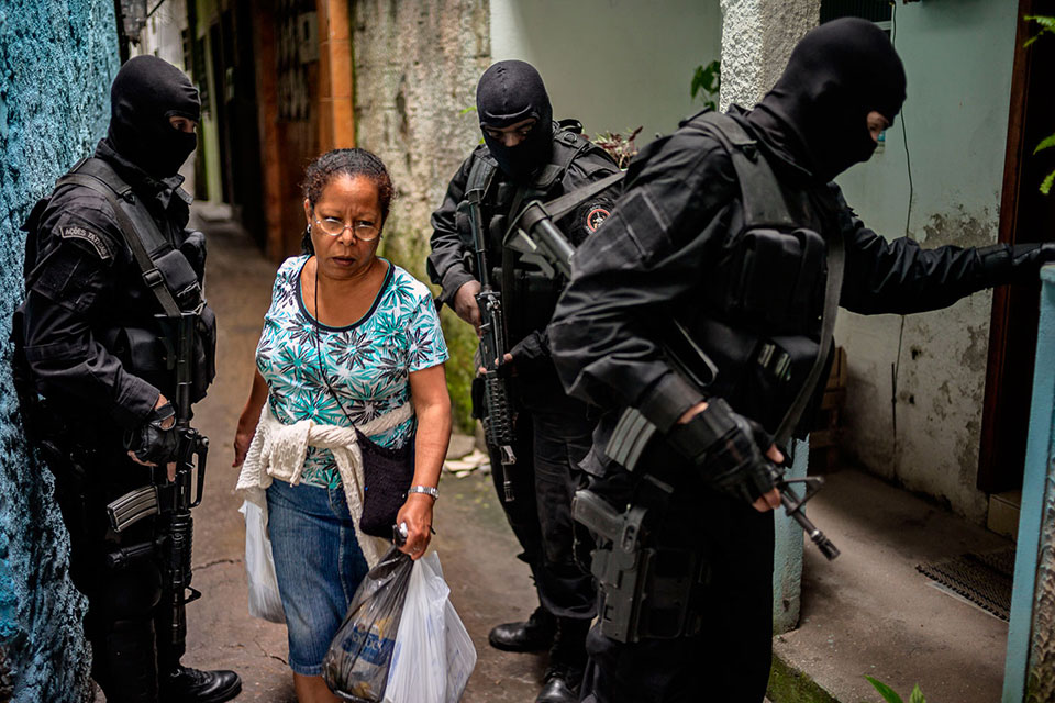 BRAZIL. Rio de Janeiro. 2010. Members of the elite squad BOPE (the Special Police Operations Battalion of the Military Police) train in the Tavares Bastos favela adjacent to BOPE headquarters, in Laranjeiras. In places experiencing or at risk of conflict, women, men, boys and girls face differentiated security threats that require tailored responses. But these have received little attention in security reform, resulting, for example, in lost opportunities to recruit more women into security forces which can broaden trust and address gender-specific concerns such as sexual violence.  ©David Alan Harvey/Magnum Photos