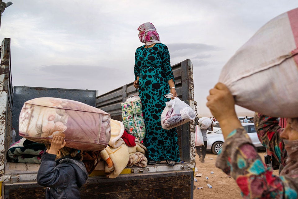 TURKEY. Suruc. 2014. Syrian Kurdish refugees enter Turkey from the town of Kobani, Syria and surrounding villages. Conflict in Syria is still raging, contributing to the biggest refugee crisis since World War II. The world is now facing the largest refugee crisis since World War II: at the end of 2014, the number of forcibly displaced persons rose to 59.5 million — one of the highest numbers ever recorded. Women and girls, who represent half of refugees and displaced people, face discrimination and gender-based violence when they are displaced. Protection and humanitarian assistance to refugees and displaced people must integrate gender perspectives and ensure women are also part of the design and implementation of these efforts. ©Michael Christopher Brown/Magnum Photos