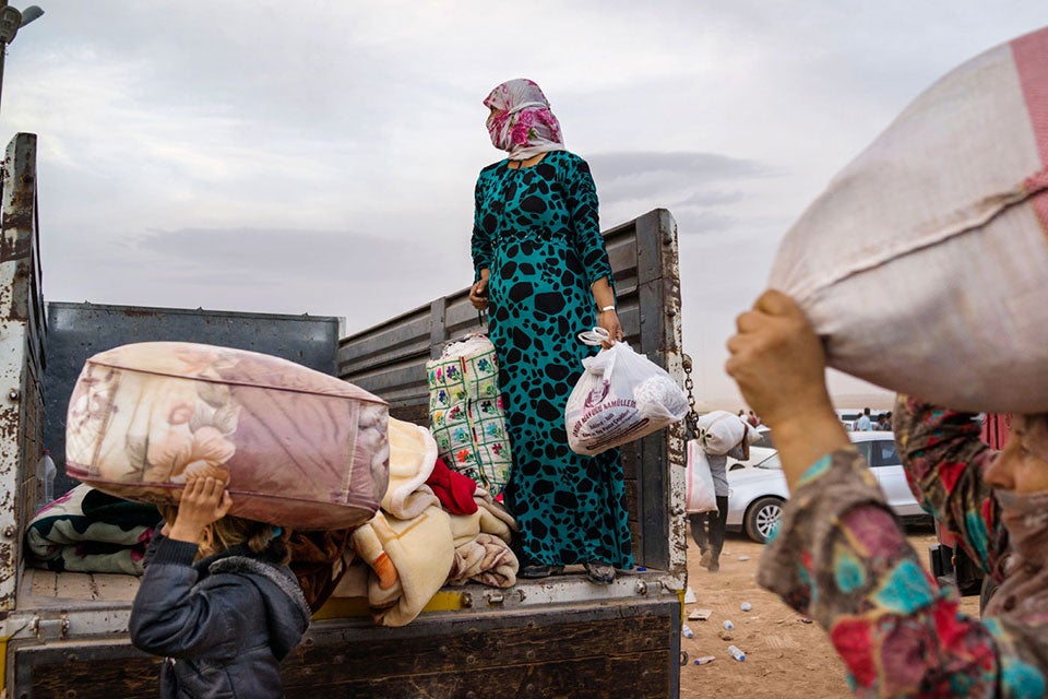 TURKEY. Suruc. 2014. Syrian Kurdish refugees enter Turkey from the town of Kobani, Syria and surrounding villages. Conflict in Syria is still raging, contributing to the biggest refugee crisis since World War II. The world is now facing the largest refugee crisis since World War II: at the end of 2014, the number of forcibly displaced persons rose to 59.5 million — one of the highest numbers ever recorded. Women and girls, who represent half of refugees and displaced people, face discrimination and gender-based violence when they are displaced. Protection and humanitarian assistance to refugees and displaced people must integrate gender perspectives and ensure women are also part of the design and implementation of these efforts.  ©Michael Christopher Brown/Magnum Photos