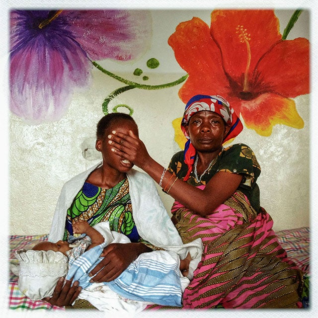 DEMOCRATIC REPUBLIC OF THE CONGO. Goma. 2012. A 16-year-old girl from a village near the mining town of Numbi was assaulted by three Hutu militia fighters, one of whom impregnated her. She was at a clinic in Goma with her child and her mother, who is covering her face. As a result of historic Security Council resolutions 1325 and 1820, sexual violence has been recognized as a tactic of warfare, requiring training on sexual violence for peacekeepers and national security forces as well as justice and services for survivors of sexual violence. ©Michael Christopher Brown/Magnum Photos