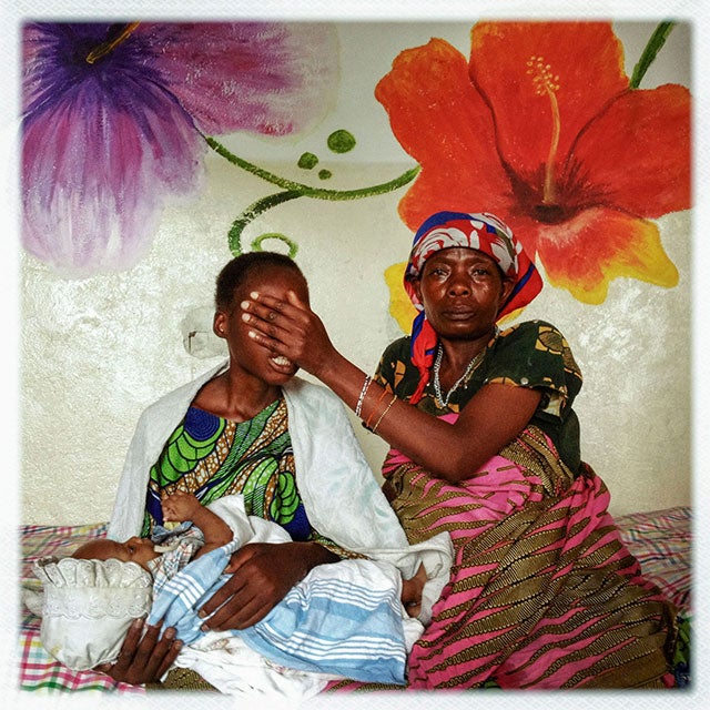 DEMOCRATIC REPUBLIC OF THE CONGO. Goma. 2012. A 16-year-old girl from a village near the mining town of Numbi was assaulted by three Hutu militia fighters, one of whom impregnated her. She was at a clinic in Goma with her child and her mother, who is covering her face. As a result of historic Security Council resolutions 1325 and 1820, sexual violence has been recognized as a tactic of warfare, requiring training on sexual violence for peacekeepers and national security forces as well as justice and services for survivors of sexual violence.  ©Michael Christopher Brown/Magnum Photos