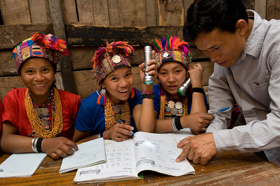 In a remote village in Lao People’s Democratic Republic, young women study the national language.  Photo: UNDP/Ari Vitikainen