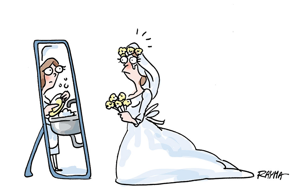 a woman looks in the mirror on her wedding day 