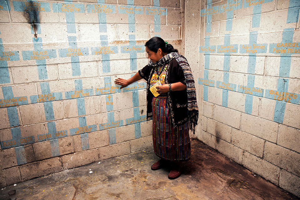 Inside the memorial, Rosalina touches the name of her father Francisco Javier Tuyuc Bal. Photo: UN Women/Ryan Brown