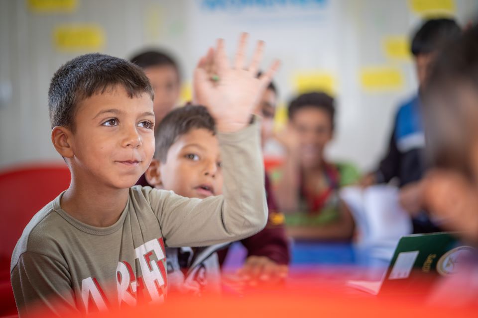 Students engage in Fatima’s literacy lessons at the UN Women Oasis in Azraq refugee camp. Photo: UN Women/Christopher Herwig