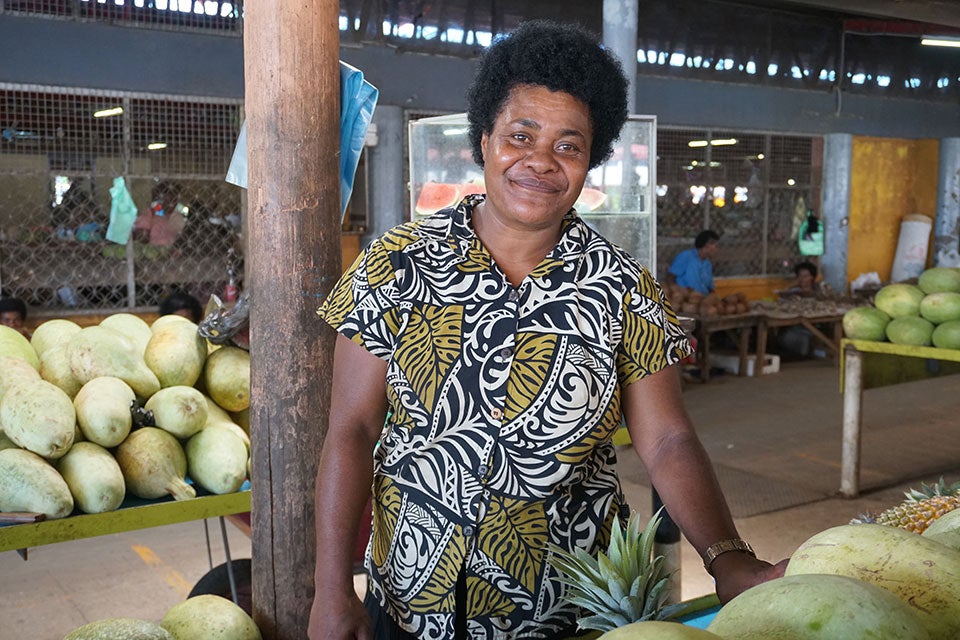 Ateca Ligatabua selling fruit and vegetables at her stall. Photo: UN Women/Caitlin Gordon King