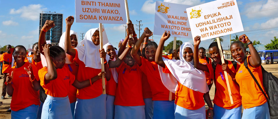 Young school girls organize themselves before the March to End Gender-Based Violence in Dar es Salaam, Tanzania.  One sign reads: "Refrain from using abusive language for Women and Children"  Photo: UN Women/Deepika Nath