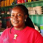 Tina Tuonyon is a 37-year-old single mother who used to sell charcoal at a small market stall. She is now a cross-border trader with a big clothing and household goods shop. Photo: UN Women/Arwen Kidd