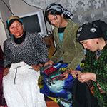 Anjira Ashurova (centre) and other members of the self-help groups in her community work together in Isfara district, Sughd Province, Tajikistan.  Photo credit: Association of Women and Society